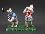 two figurines of a cat and a cat playing golf