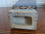 a small box sitting on top of a wooden table
