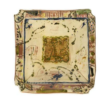 a small square plate with a painting on it