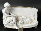 porcelain figurine of a woman sitting on a couch with a dog