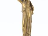 bronze statue of a woman holding a child on a marble base