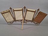three antique picture frames with a wooden stick on a gray background
