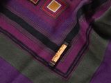 purple, black, and brown blanket with squares and squares on it