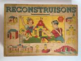 an old board game with a picture of a boy and a girl playing with blocks