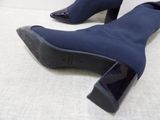 pair of women ' s blue sued ankle boots on a white surface
