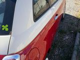 a red and white car parked on the side of the road