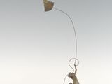 a sculpture of a man flying a kite on a rock