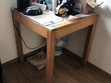 a small table with a coffee maker on it in the corner of a room