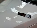a sticker on the hood of a white car