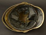 a gold plate with a picture of a woman on it