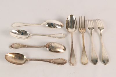 a lot of silver spoons and spoons on the table