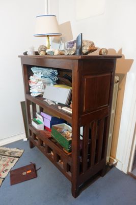 an image of a room with a book shelf and a lamp