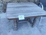 a wooden table and two chairs on the patio