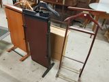 two wooden clothes racks and a metal rack in a room