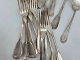 a lot of silver spoons and forks on the table