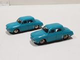 two toy cars that are sitting on a white surface