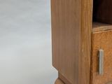 a small wooden cabinet with a marble top