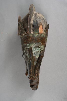 a sculpture of a horse ' s head hanging on a wall
