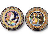 two decorative plates with a painting of a woman and a man