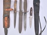 many different types of knives on a white surface