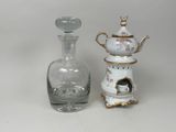 two vases and a bottle sitting on a table