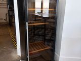 a wine cooler that is sitting in the corner of a room