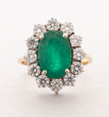 an oval emerald and diamond cluster ring