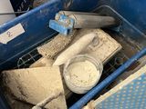 a blue container filled with items sitting on a table