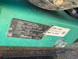 a close up of a green motorcycle with a sticker on it