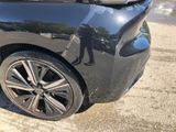 a black car that is parked on the side of the road