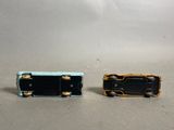 two miniature pieces of luggage sitting on a table