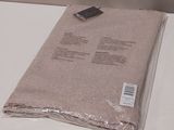 a blanket on a table with a remote control on it