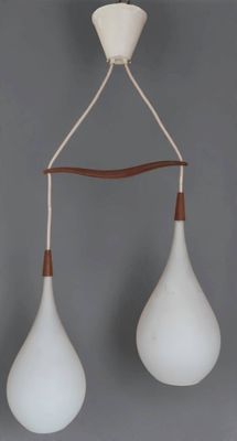 two white and brown hanging lamps on a gray wall