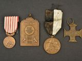 three medals and a medal on a black surface