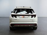 the rear end of a white suv parked in a white room