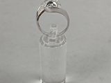 an image of a diamond and pearl ring in a clear container