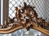 a mirror with a gold frame and a mirror with a mirror on top of it