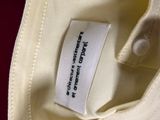 a label on a white shirt that says, the label is on the back of a white shirt