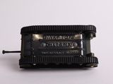 a black and silver music box on a white surface