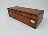 an image of a small wooden box with a tag on it