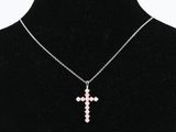 a necklace with a cross pendant on a mannequin neck