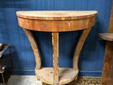 a small table with a wooden top in a room