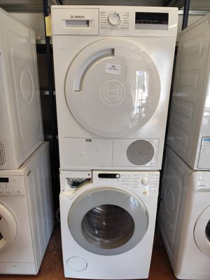 trois lave-linge et un sèche-linge empilés les uns sur les autres
