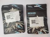 two bags of marijuana seeds sitting on a table
