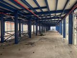 a large room with a lot of windows and a lot of scaffolding on the ceiling