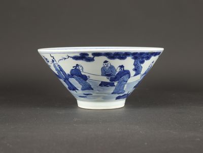 a blue and white bowl with figures in a landscape