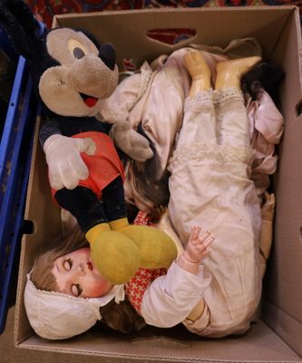 a small child laying in a cardboard box with stuffed animals
