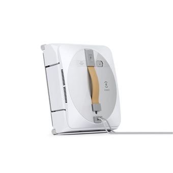 un petit appareil blanc branché à un chargeur posé sur une surface blanche