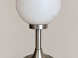 an image of a white glass ball sitting on top of a metal stand