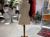 a mannequin on a stand in the middle of a room